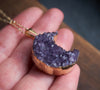 Chunky amethyst crystal moon necklace in hand
