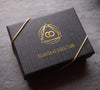 Matte black jewelry gift box printed with a gold Curious Oddities logo
