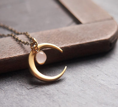 Matte gold crescent moon necklace with delicate moonstone accent