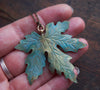 Back view of large blue green maple leaf necklace 