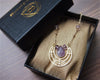 Gold geometric necklace with raw amethyst