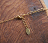 Detail of 24k matte gold plated chain with lobster clasp and extender chain